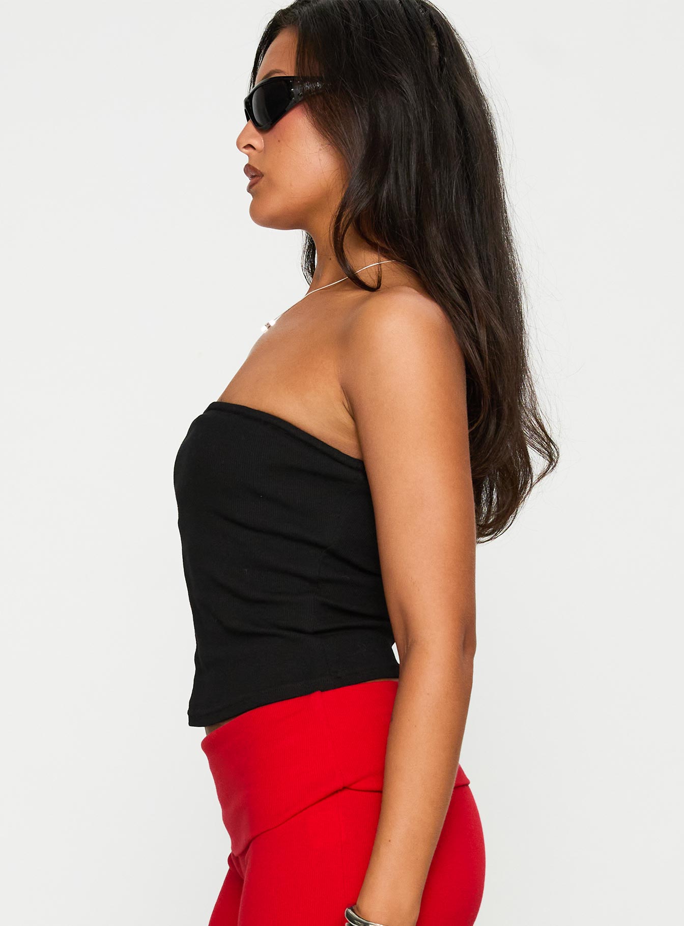 side view of model wearing Princess Polly Baseline Strapless Rib Top Black Sleeveless straight 