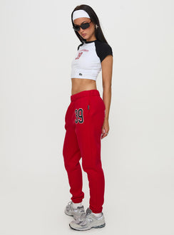 side view of model wearing Princess Polly BU Sweatpants Red High Waisted Pants 