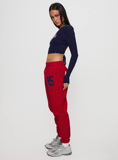 back view of model wearing Princess Polly U of A Sweatpants Red Low Rise Pants 