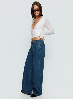 side view of model wearing Princess Polly Lando Low Rise Straight Leg Jeans Mid Blue Wash Mid Rise Jeans 