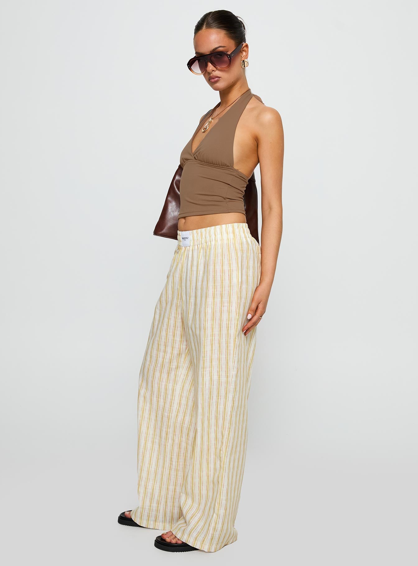side view of model wearing Princess Polly Beach House Pants Yellow Stripe High Waisted Pants 