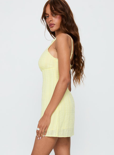 side view of model wearing Princess Polly I Know Places Mini Dress Lemon Scoop Neck 