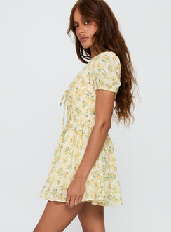 side view of model wearing Princess Polly Ethelyn Mini Dress Yellow Floral V-Neck 
