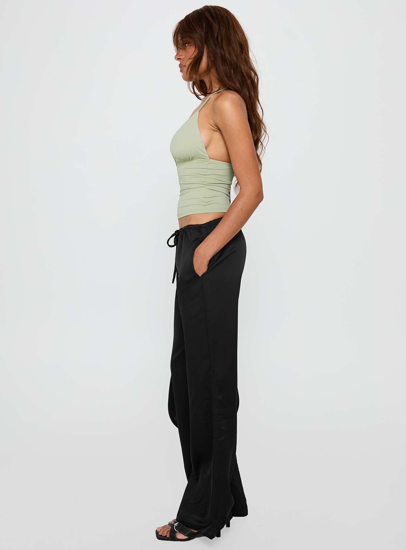 side view of model wearing Princess Polly Vanille Tie Waist Satin Pants Black Low Rise Pants 