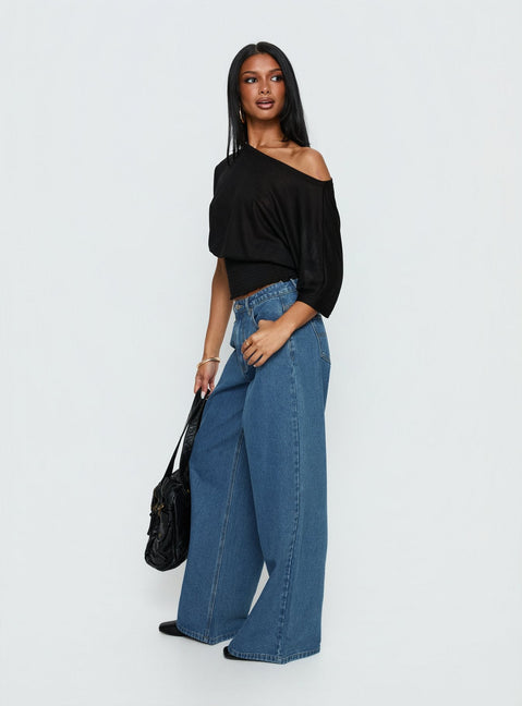 back view of model wearing Princess Polly Naylor Mid Rise Wide Leg Jeans Mid Blue Wash Mid Rise Jeans 