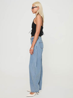 side view of model wearing Princess Polly Horseshoe Jeans Washed Blue High Waisted 