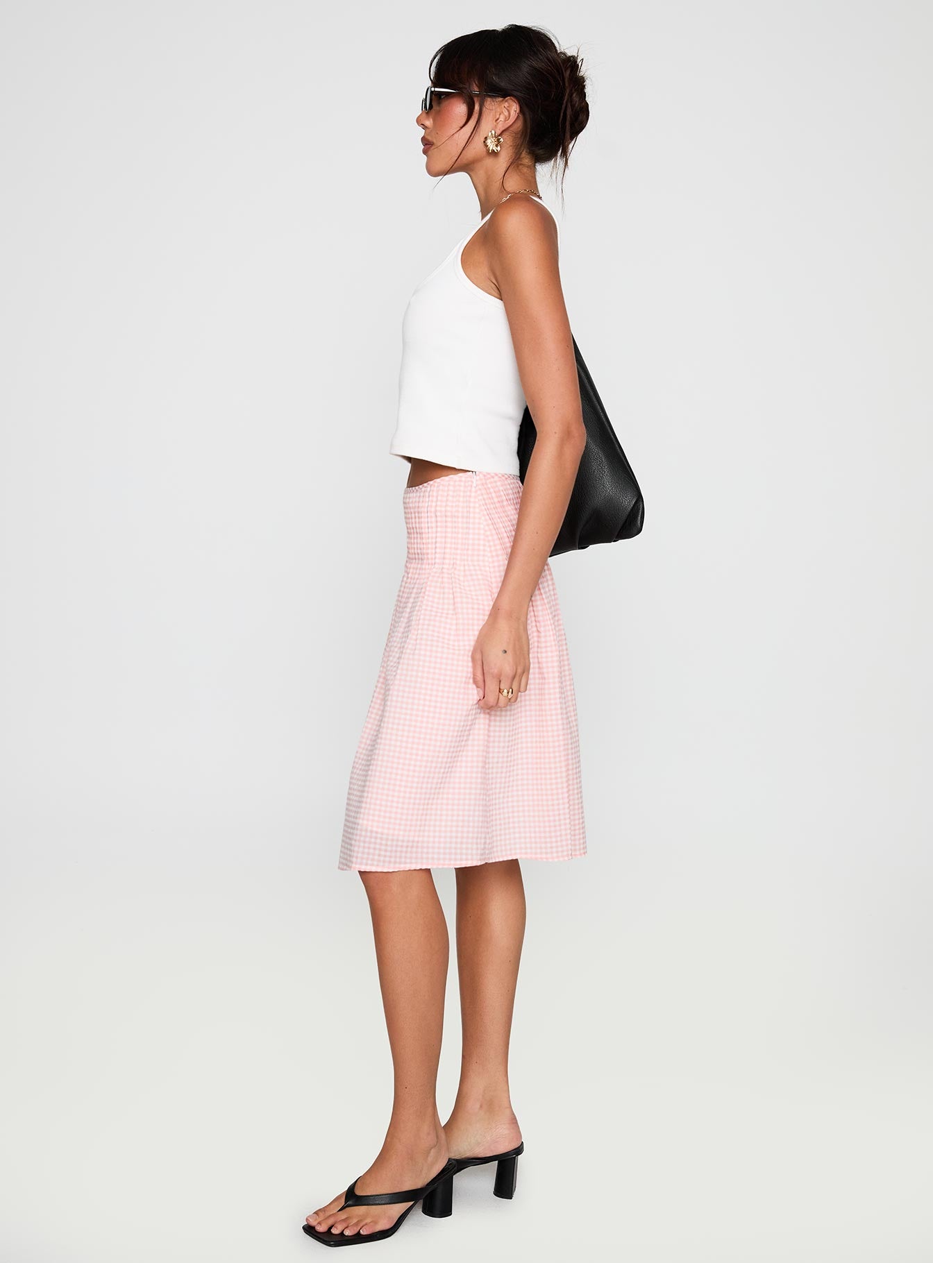   side view of model wearing Princess Polly Maryanna Midi Skirt Pink Gingham 