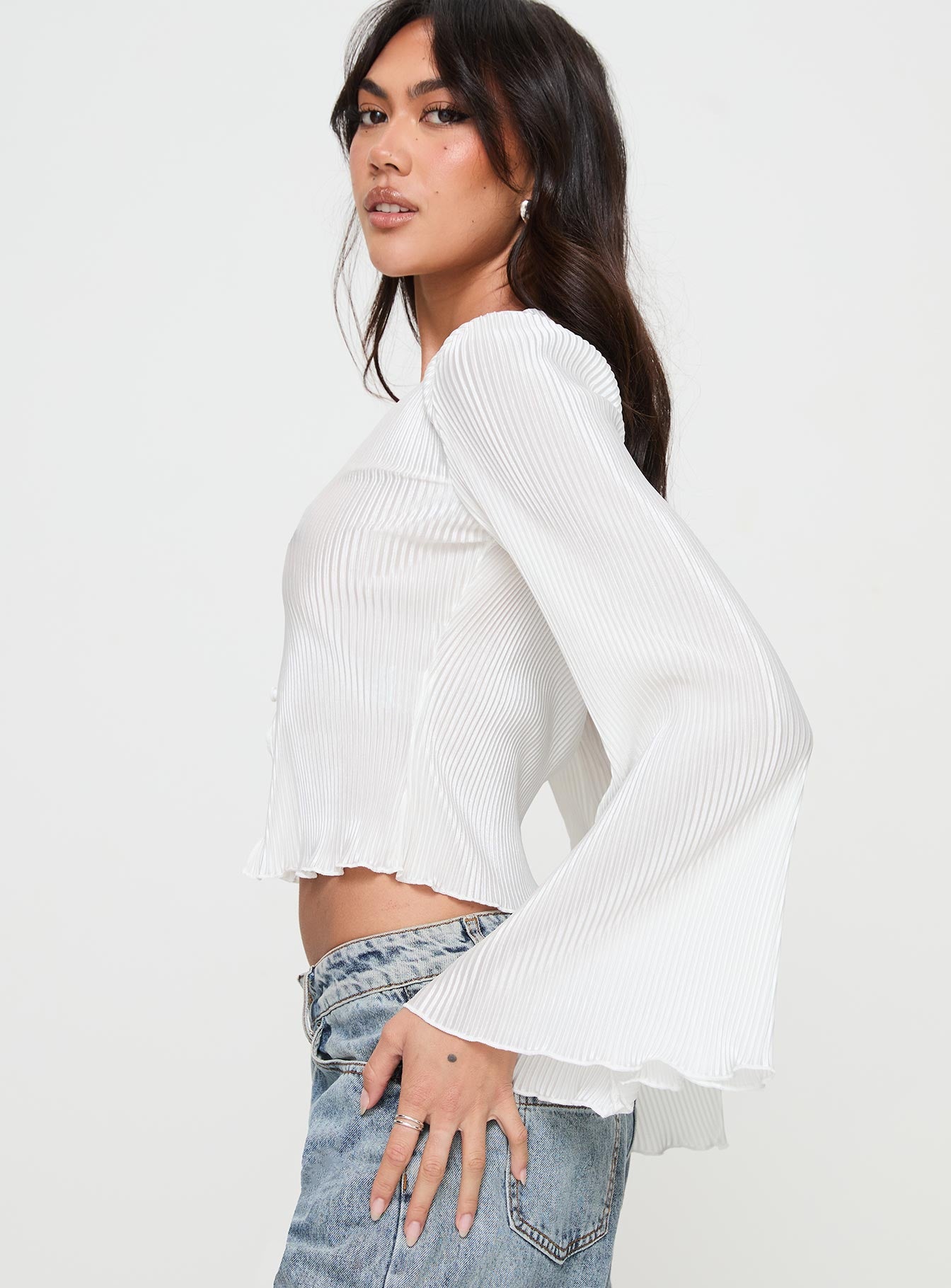 side view of model wearing Princess Polly Collis Long Sleeve Top Cream Full Sleeves V-Neck 