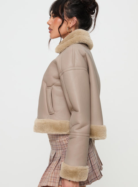 Beige Faux leather jacket Gold toned hardware, zip fastening down front, buckle fastening at neck, twin hip pockets