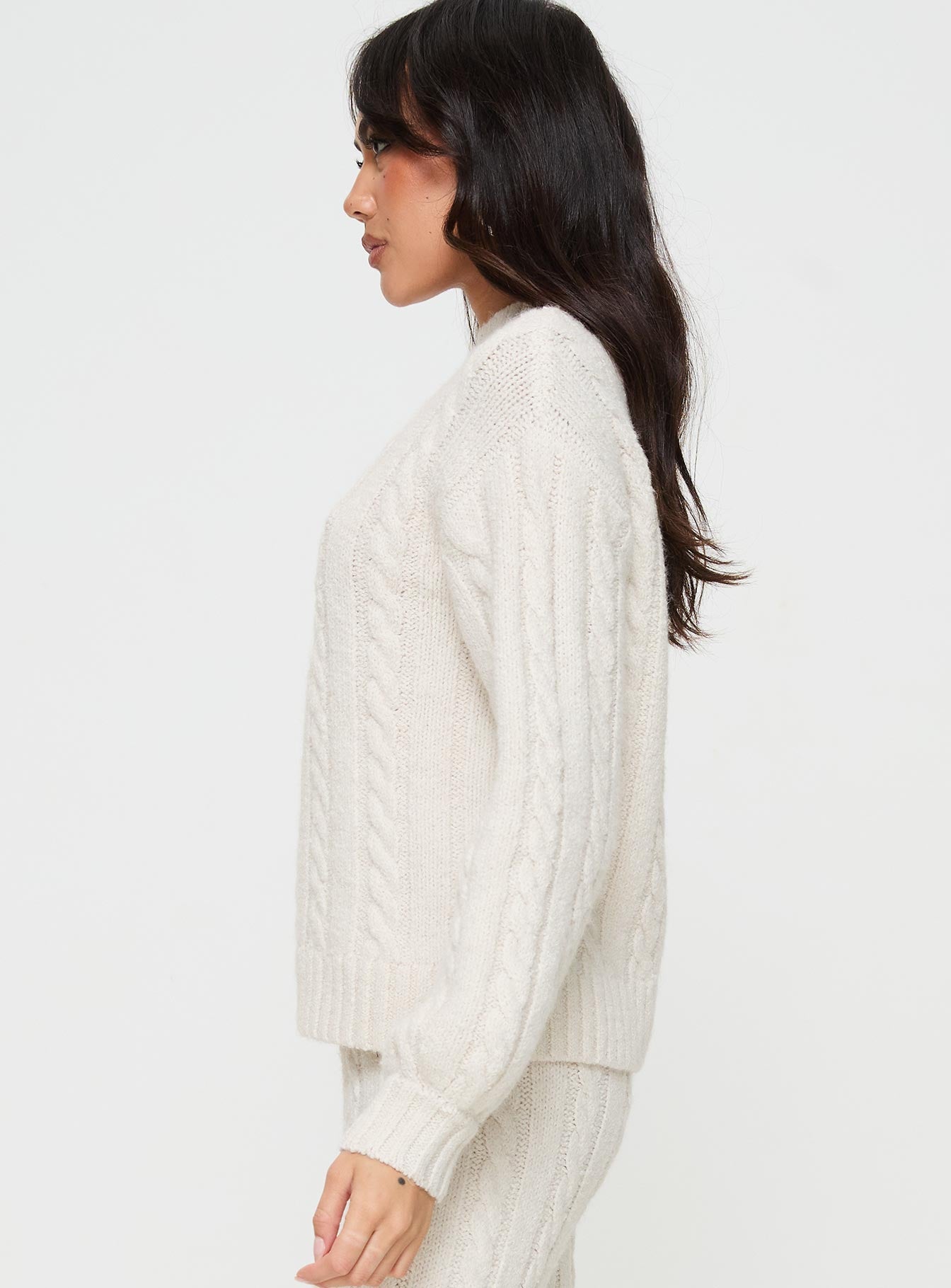 side view of model wearing Princess Polly Sharif Cable Knit Sweater Beige regular 