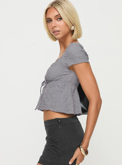 side view of model wearing Princess Polly Kellan Cap Sleeve Top Blue Short Sleeves Plunger 