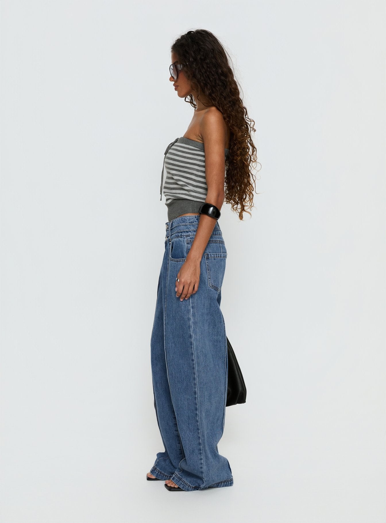 side view of model wearing Princess Polly Hannalee Low Rise Wide Leg Jeans Mid Blue Wash Low Rise Jeans 