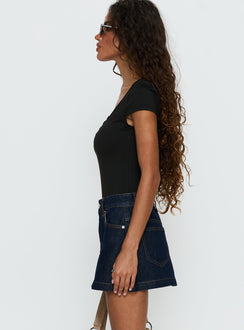   side view of model wearing Princess Polly Nicolina Low Rise Denim Mini Skirt Raw Denim Mini Skirts 