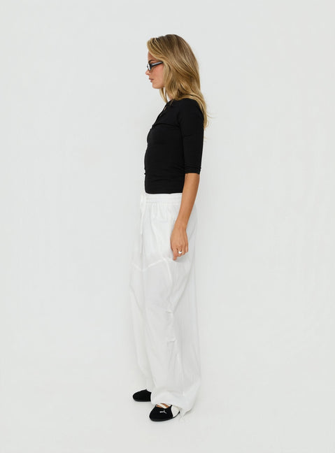Explore the Mankind Baggy Cargo Pants White in womens-regular-pants with mid-rise, side view of model wearing Princess Polly