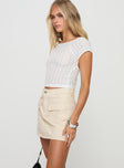 side view of model wearing Princess Polly Cadern Skort Cream High Waisted Shorts 