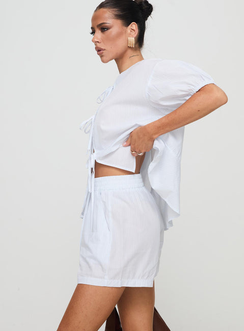 side view of model wearing Princess Polly Sunblind Shorts White High Waisted Shorts 