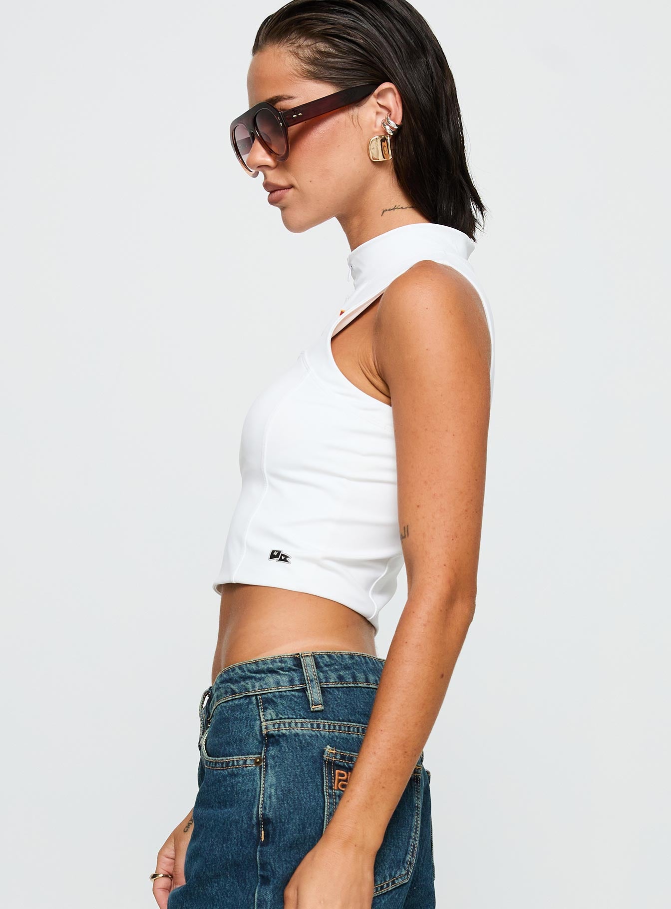 side view of model wearing Princess Polly USC Belle Tank Top White Sleeveless High Neck 