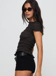 side view of model wearing Princess Polly Romelle Shirred Top Black / Brown Plaid Short Sleeves High Neck 