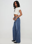 side view of model wearing Princess Polly Leslee Flare Jean Mid Wash Blue Mid Rise 