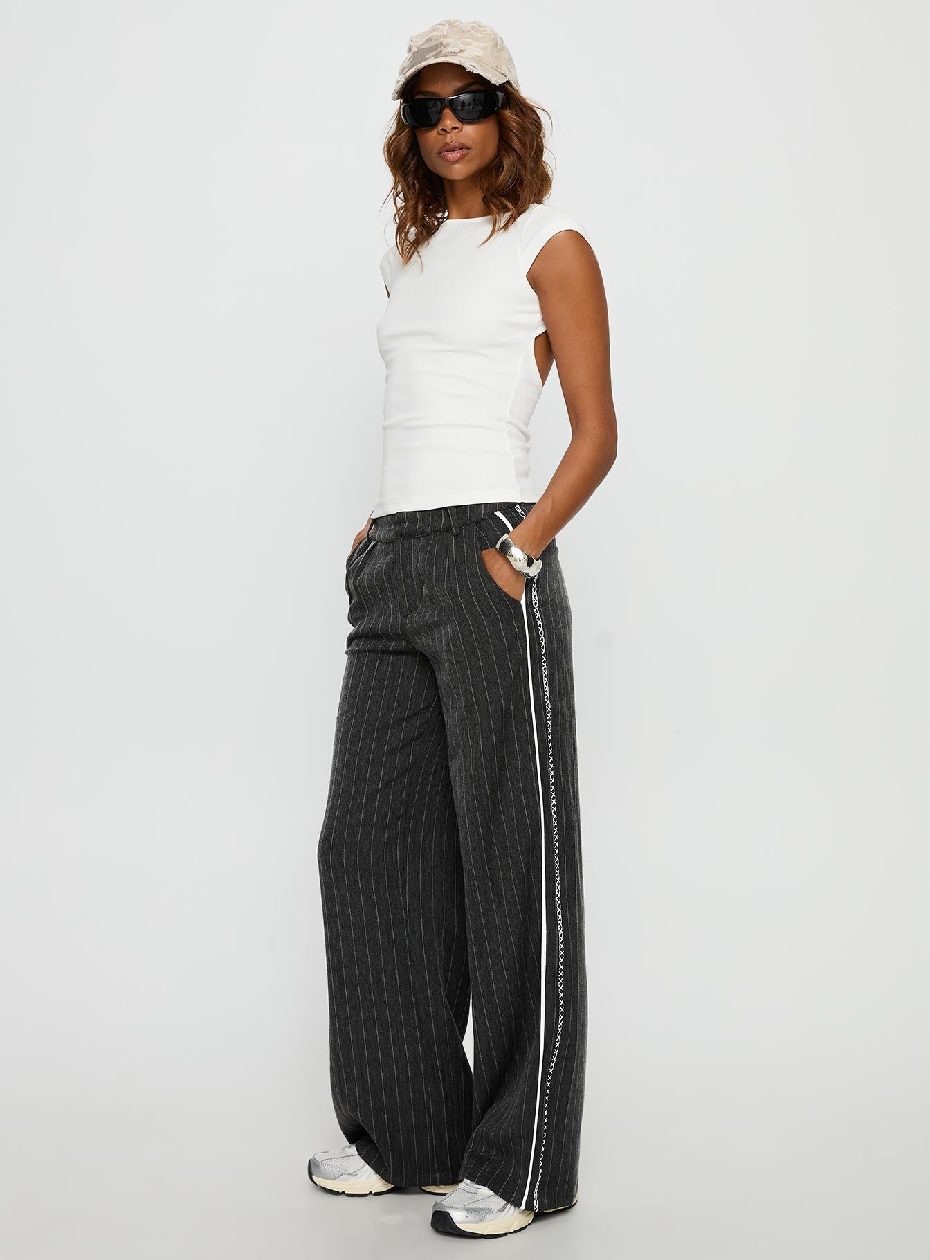 side view of model wearing Princess Polly Knowla Pleated Trouser Pant Grey Pinstripe Mid Rise Pants 
