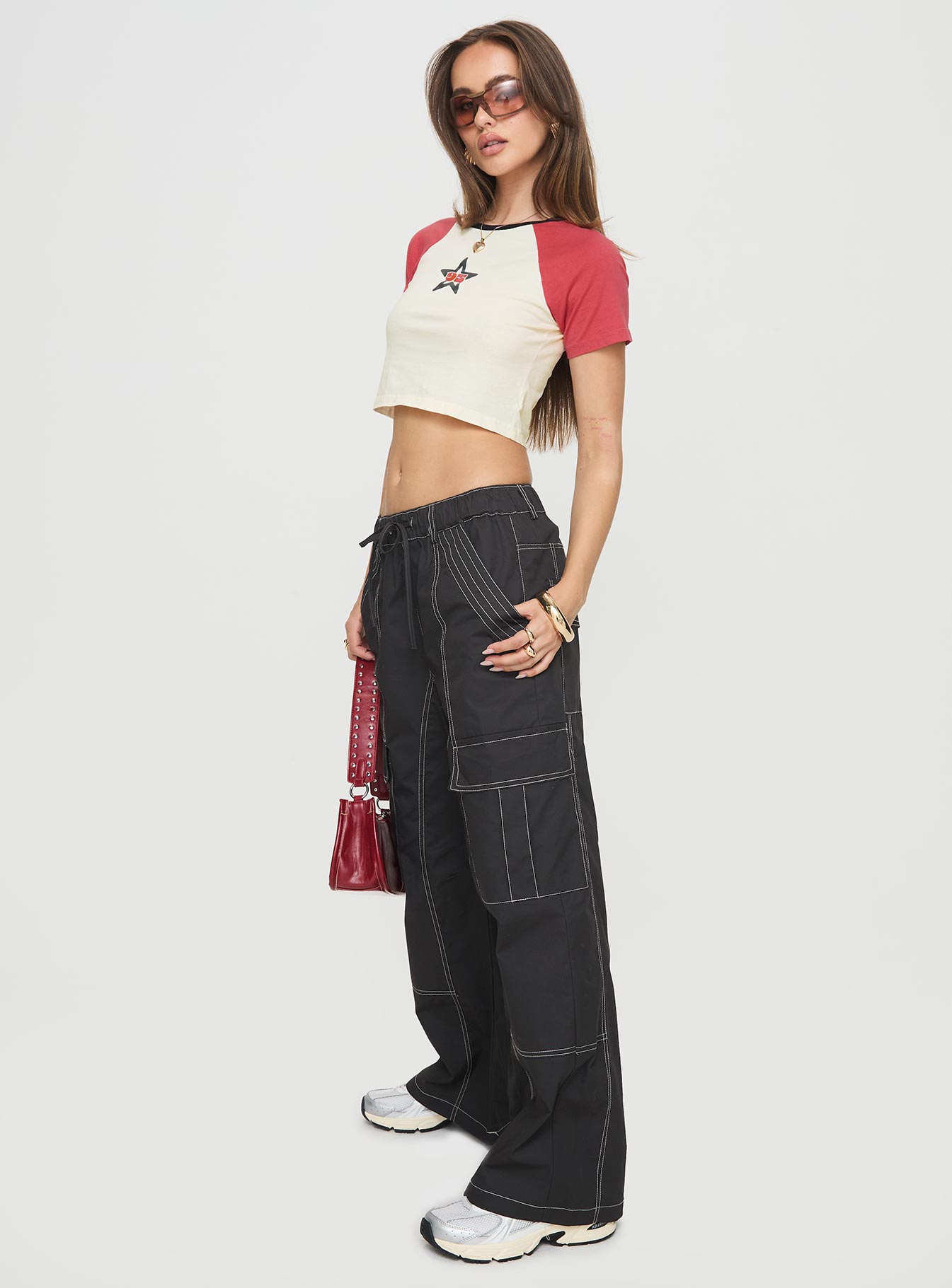 side view of model wearing Princess Polly Soria Cargo Pants Black Low Rise Pants 