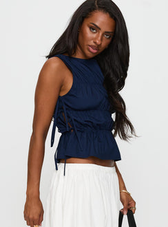 side view of model wearing Princess Polly Endless Summers Tie Side Top Navy Sleeveless High Neck 