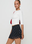   side view of model wearing Princess Polly Dapple Bias Mini Skirt Black Polka Dot Mini Skirts 