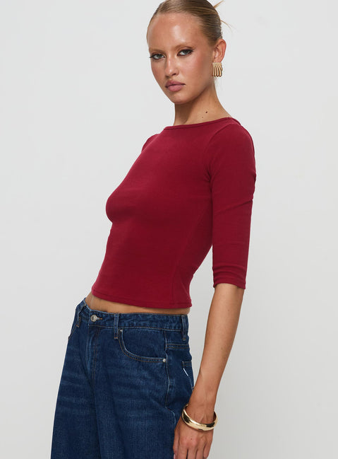side view of model wearing Princess Polly Elaia 3/4 Sleeve Top Red Three Fourth Sleeves Crew Neck 