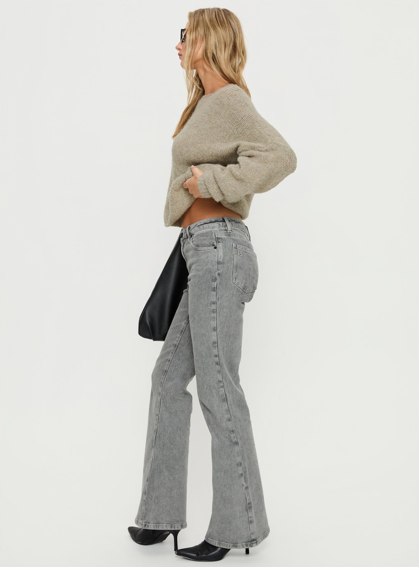 side view of model wearing Princess Polly Magic Mirror Mid Rise Bootleg Jeans Washed Grey Mid Rise Jeans 