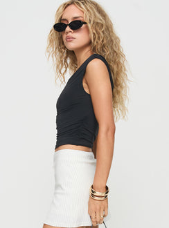 side view of model wearing Princess Polly Ander Top Black Sleeveless Asymmetric Neckline 