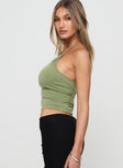 side view of model wearing Princess Polly Catalyst Asymmetrical Top Green Sleeveless Asymmetric Neckline 