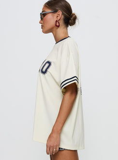 side view of model wearing Princess Polly Cornwall Football Jersey Cream Half Sleeves Crew Neck 