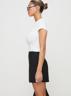 side view of model wearing Princess Polly Grant My Wish Mini Skort Black High Waisted Shorts 