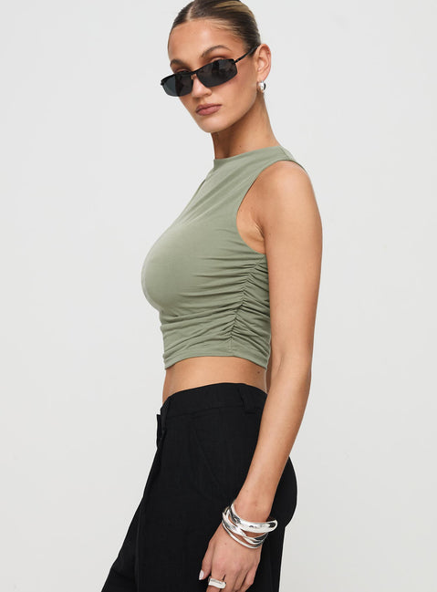 side view of model wearing Princess Polly Hold Em High Neck Top Green Sleeveless Crew Neck 