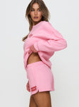 side view of model wearing Princess Polly Princess Polly Sweat Short Bubble Text Pink / Red High Waisted Shorts 