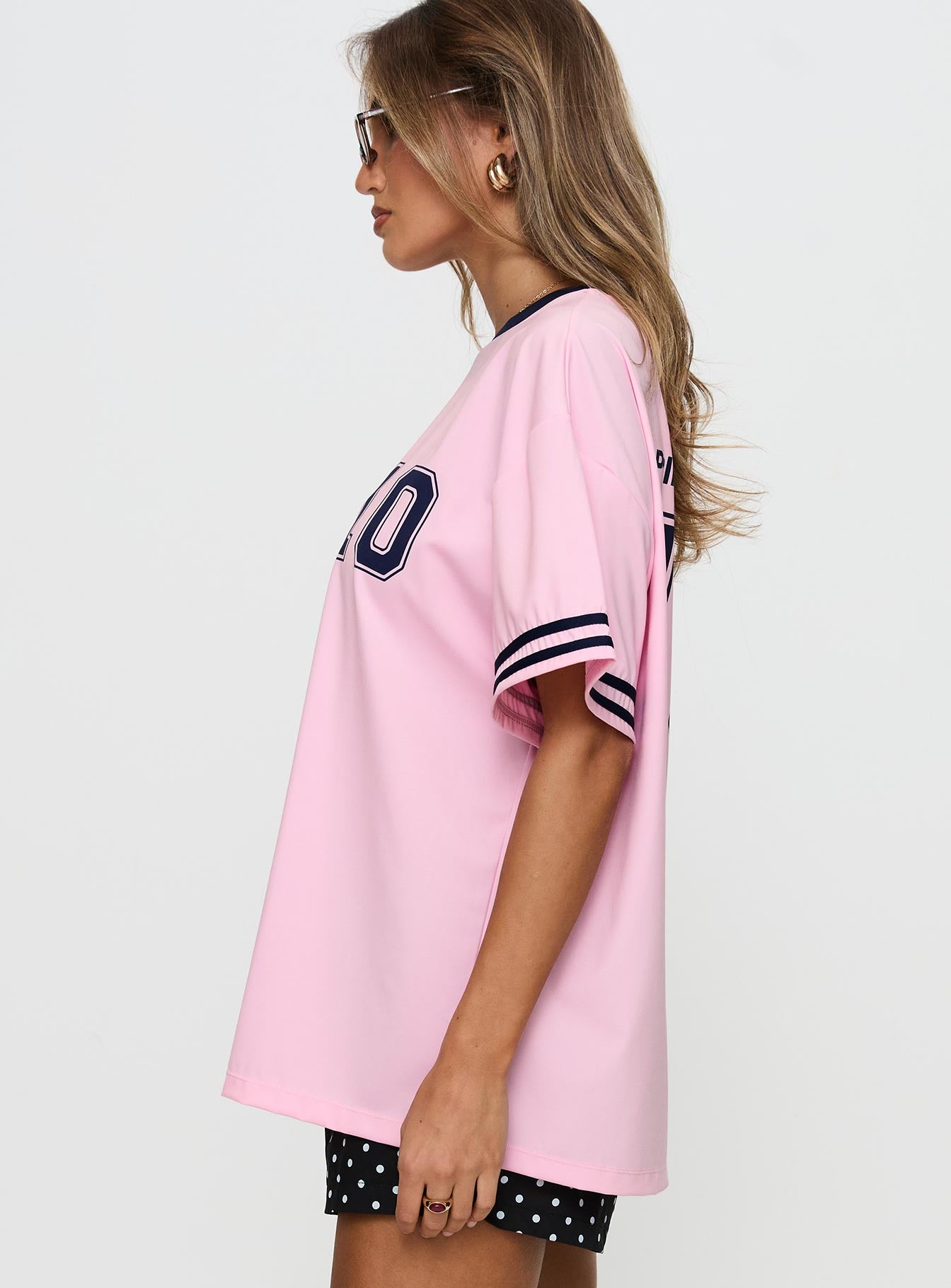 side view of model wearing Princess Polly Cornwall Football Jersey Pink Half Sleeves Crew Neck 