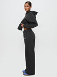 side view of model wearing Princess Polly Princess Polly Wide Leg Track Pant Bubble Script Charcoal High Waisted Pants 