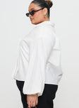 side view of model wearing Princess Polly Rinon Long Sleeve Top White Curve Full Sleeves V-Neck 