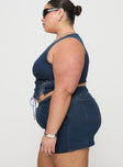   side view of model wearing Princess Polly Popular Low Rise Mini Skirt Mid Blue Wash Curve Mini Skirts 