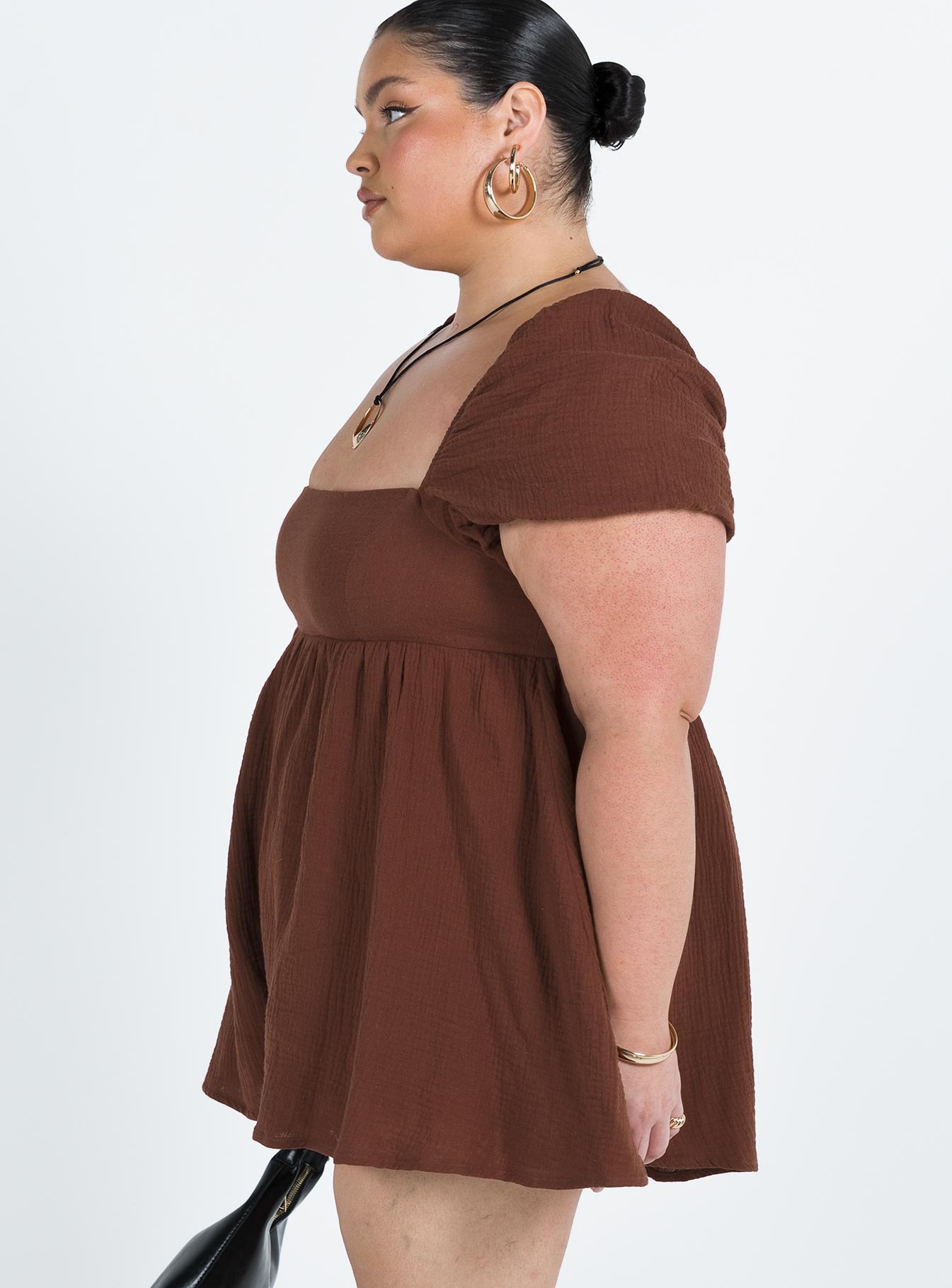 Romper Muslin material Square neckline  Elasticated puff sleeves Shirred back panel Invisible zip fastening at back  Relaxed leg 