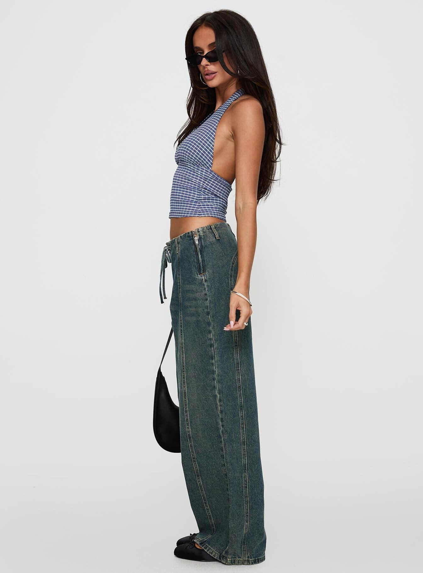 side view of model wearing Princess Polly San Mateo Tie Up Jeans Vintage Wash Low Rise Jeans 
