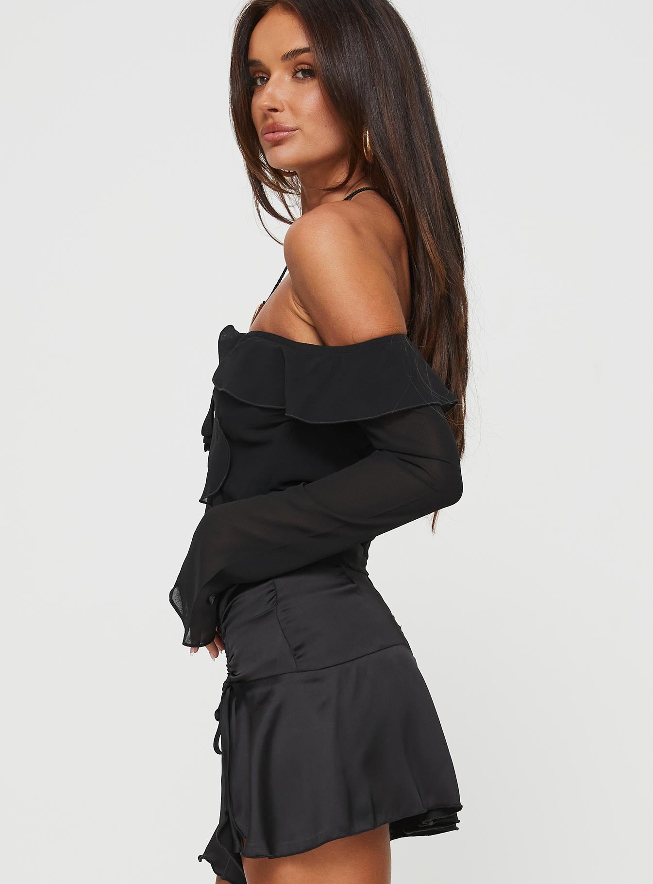 side view of model wearing Princess Polly Molins Off The Shoulder Top Black Full Sleeves straight 