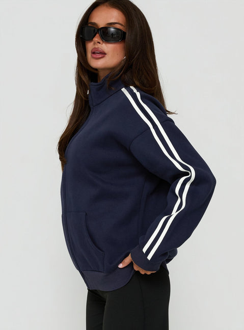 Crafted from fleece, the Keeran Funnel Neck Jumper Navy / White in womens category with short length side view of model wearing Princess Polly