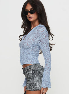 side view of model wearing Princess Polly Azai Long Sleeve Top Blue Full Sleeves V-Neck 