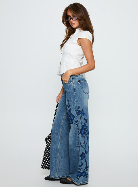 side view of model wearing Princess Polly Sisterhood Mid Rise Wide Leg Patchwork Jeans Mid Blue Wash Mid Rise Jeans 