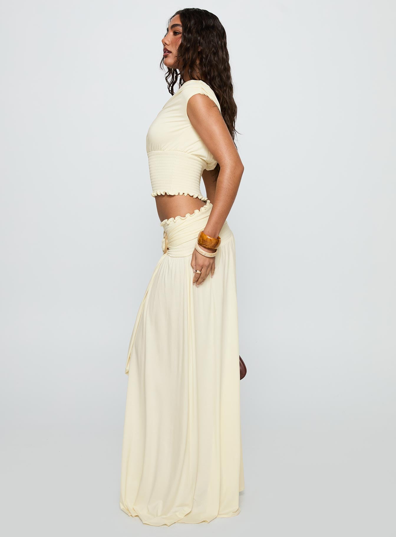   side view of model wearing Princess Polly Full Orbit Shirred Maxi Skirt Cream Maxi 