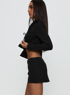 side view of model wearing Princess Polly Feminique Skort Black Stripe High Waisted Shorts 
