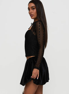   side view of model wearing Princess Polly Georgiana Bubble Hem Mini Skirt Black Mini Skirts 