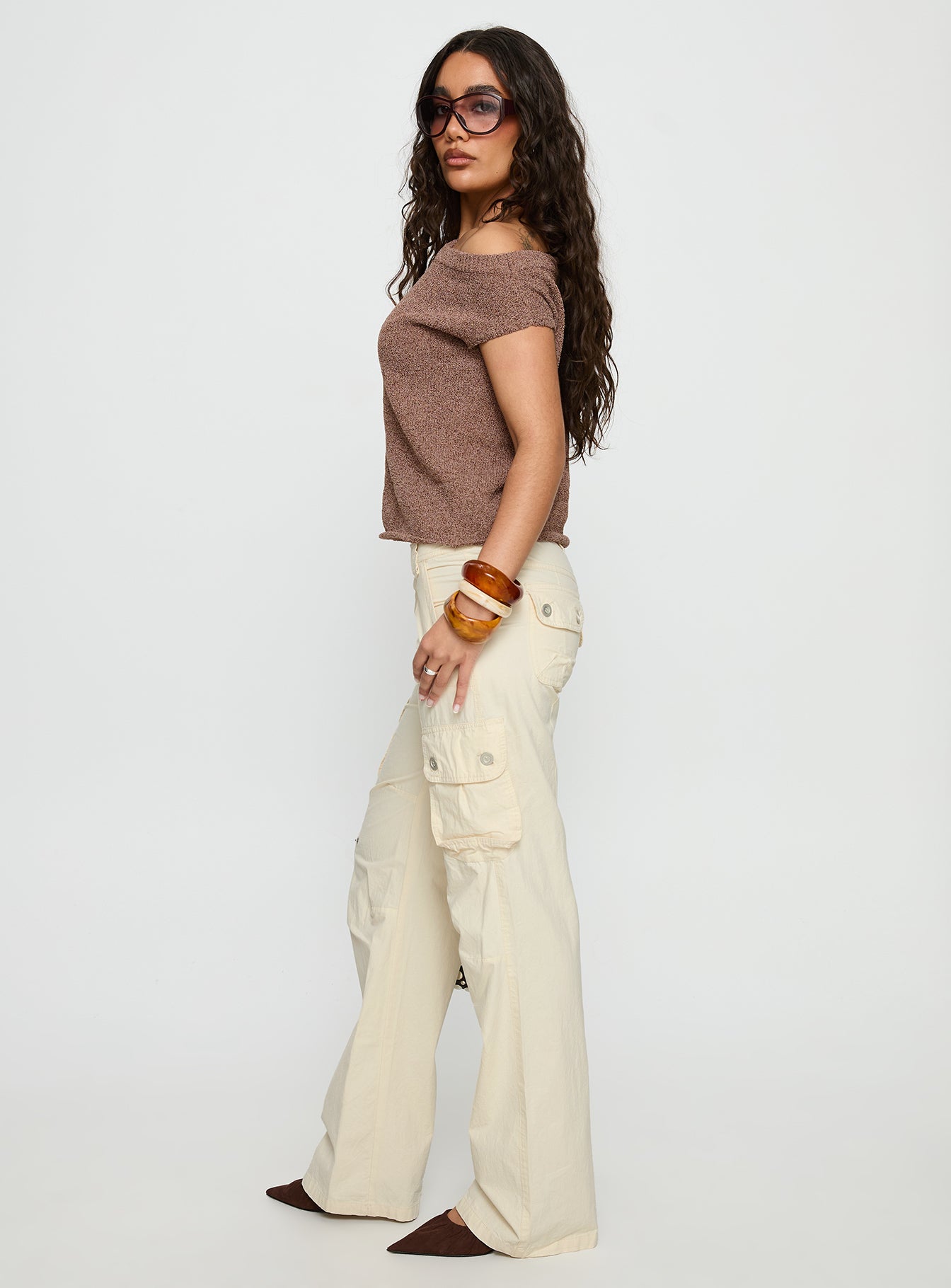 side view of model wearing Princess Polly Remmi Cargo Pants Cream Mid Rise Pants 