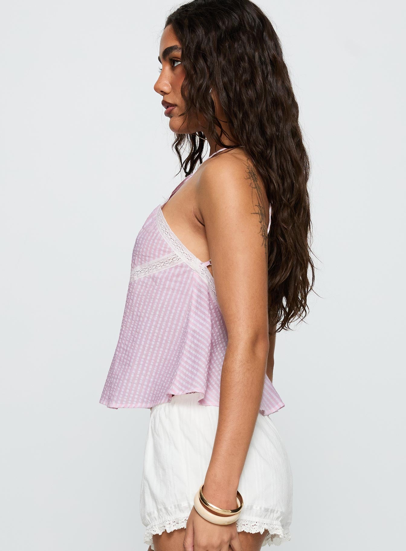 side view of model wearing Princess Polly Jezabele Halter Top Pink Stripe Sleeveless Asymmetric Neckline 
